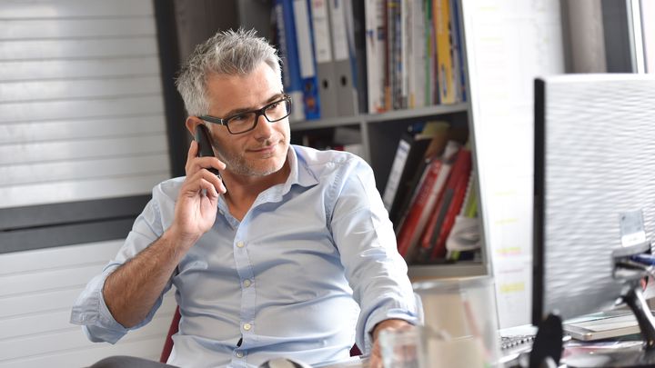 businessman in his office on his phone