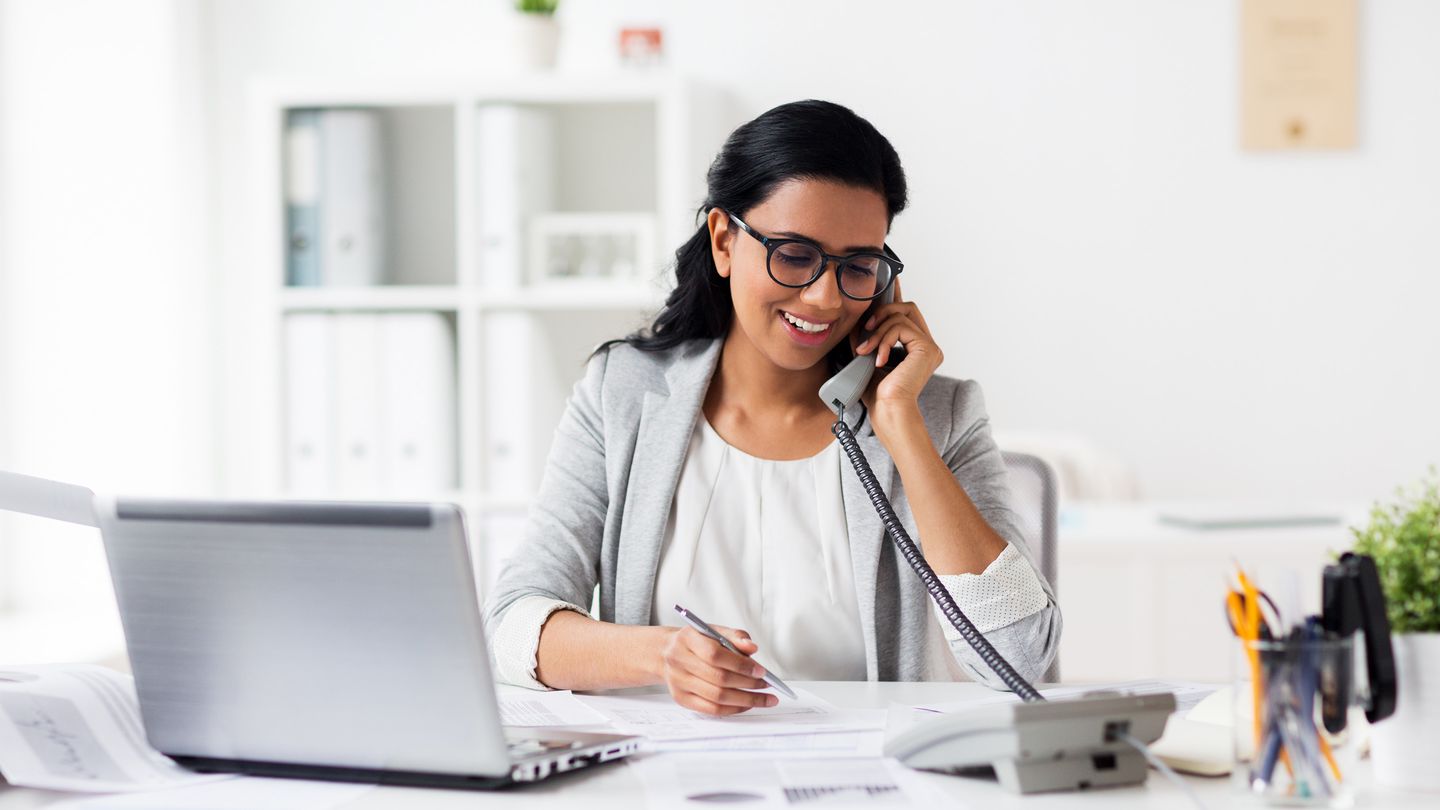 business woman in office on phone